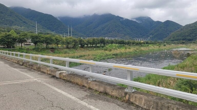 Saejae Bicycle Path winding beside a river with misty mountains near Mungyeong