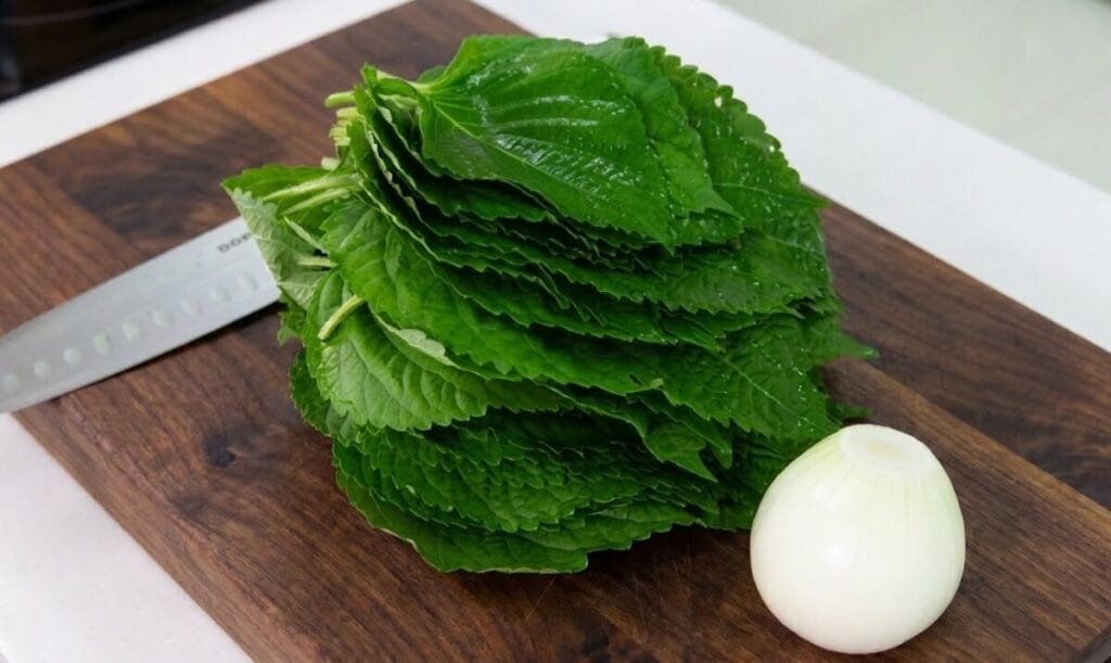 Fresh perilla leaves and onion prepped for steamed perilla leaves recipe
