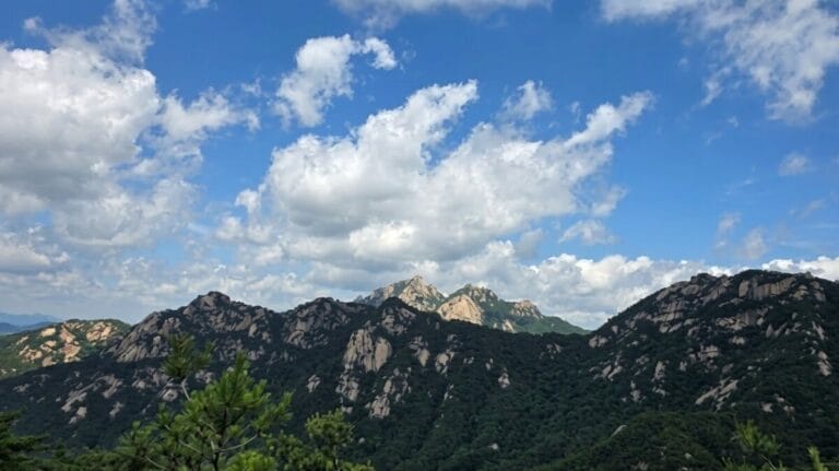 Cloud-covered ridgeline of Bukhansan seen from a nearby Seoul mountains trail