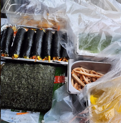 Hands rolling gimbap Eunjune Restaurant 